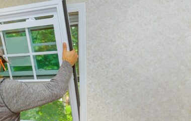 Worker in the installing new, windows in an house, with a new window in the home renovation living