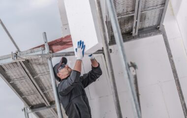 Installation Of Insulating Foam Boards On Outside Walls Of House.